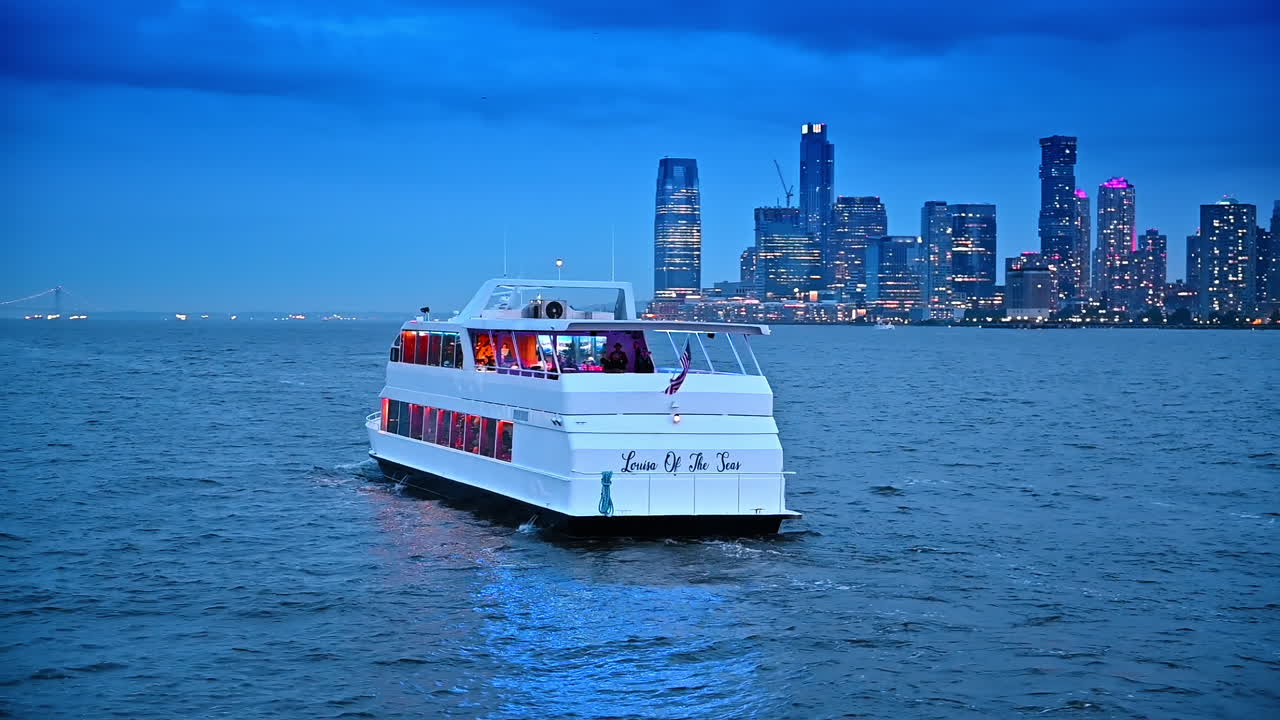 Back view of the riverboat with American flag on. River tour by the modern New York at dusk time