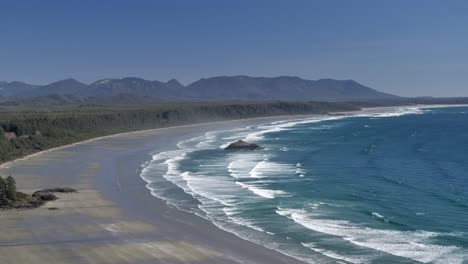 aerial view of tofino long beach and pacific ocean waves - sunny day
