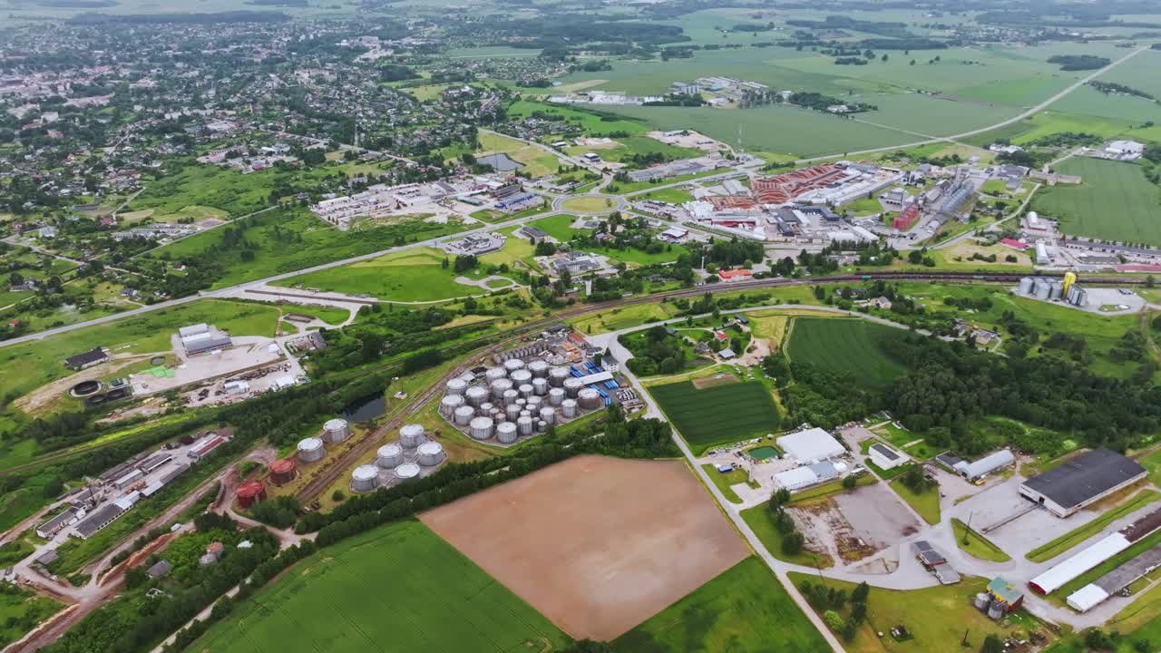 Wide aerial establishing shot shows Saldus industrial area under cloudy sky