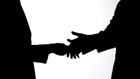 silhouette of businessman passing a bribe