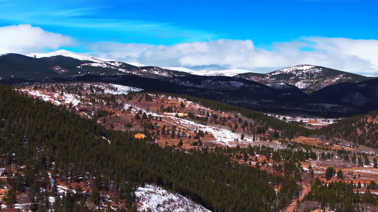 Indian Peaks Nederlan Eldora Central City Parkway Black Hawk Idaho Springs aerial drone Colorado Gilpin County winter snow historic Gold mining town bluesky sunny clouds Rocky Mountains forward motion