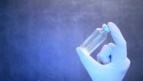 medical professional holding a vial