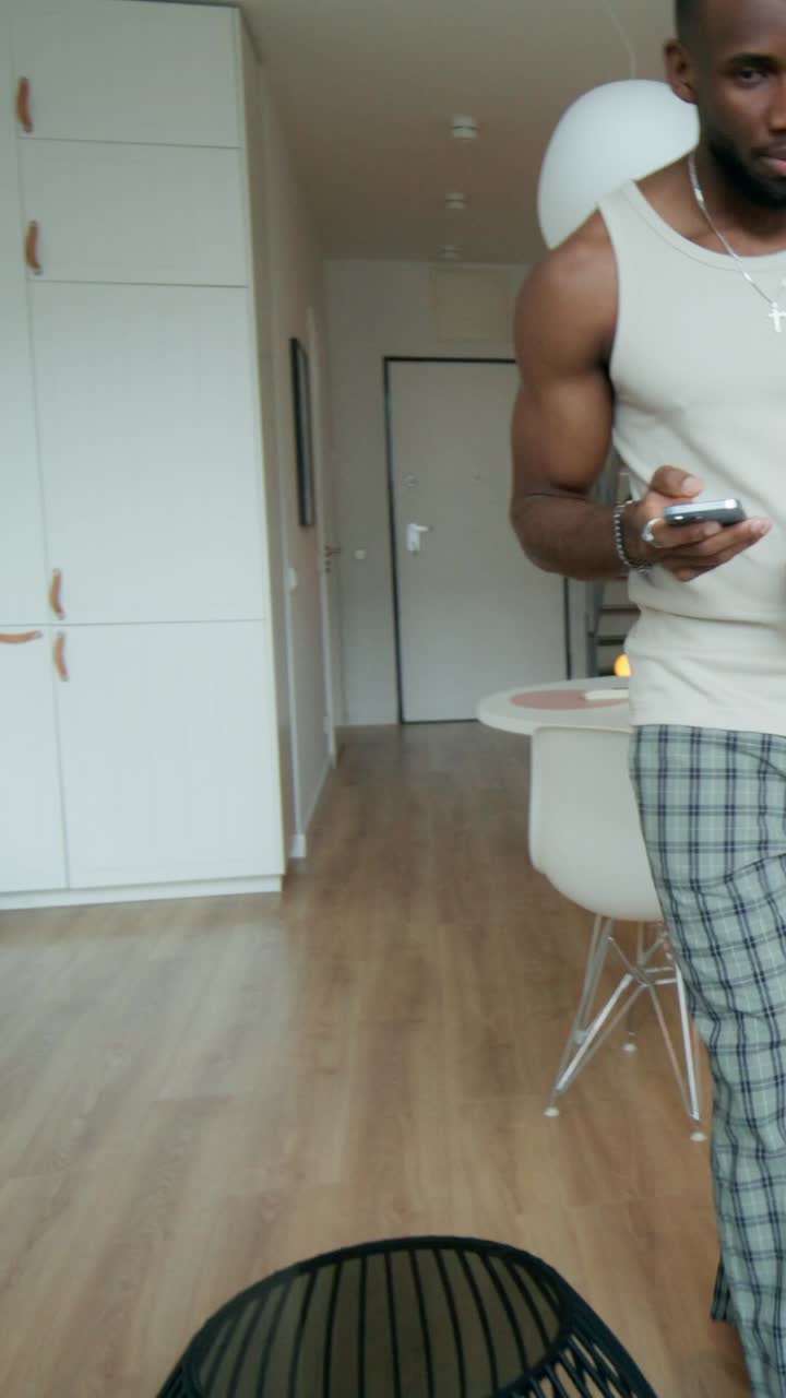 Man in Pajamas in Modern Kitchen and Dining Room