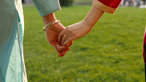 indian couple holding hands outdoors