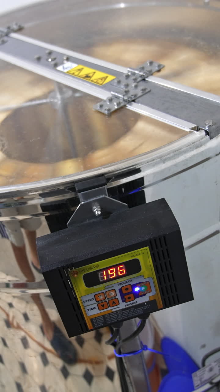 Sweet honey centifugal extracting. Honey harvesting machine. Vertical video