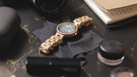 luxurious wood watch for women on black cloth on the table