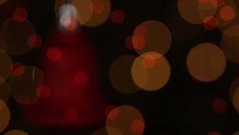 animación de la decoración de la campana roja de navidad y luces parpadeantes sobre fondo negro