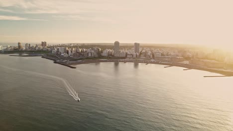 aerial tracking of a boat on the coast of mar del plata city