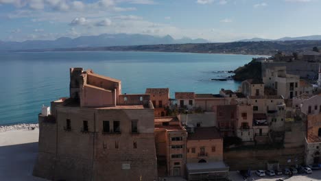 aerial dolly towards castello arabo normanno with gulf of castellammare in background