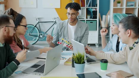 cheerful young people diverse group of designers discussing colors in office