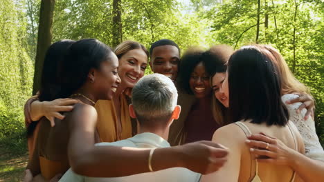diverse group of friends embracing in a forest