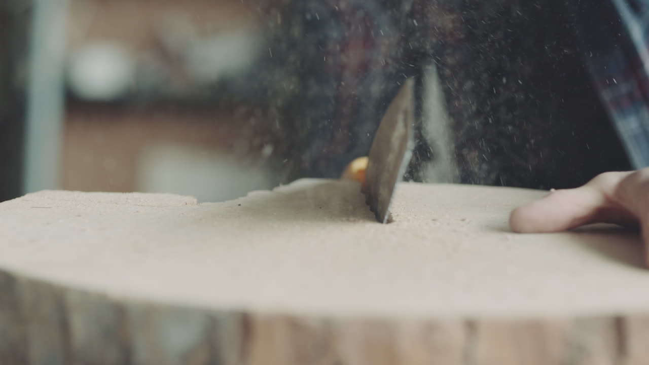 Man Sawing Thick Log with Hand Saw