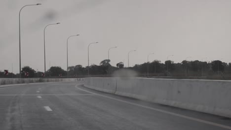 rainy day drive on a highway curve