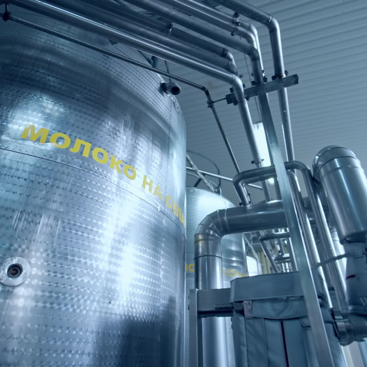 Industrial dairy production factory. Metallic stainless steel pipes in modern dairy plant
