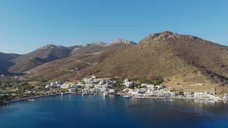 slow panning drone shot of katapola village and port in amorgos island, greece during sunrise