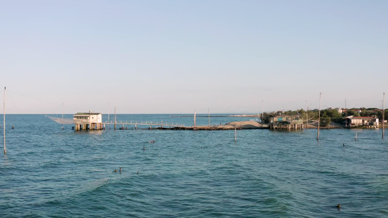 Aerial view of fishing huts with typical italian fishing machine, called "trabucco",Lido di Dante, fiumi uniti Ravenna near Comacchio valley