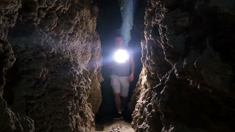 a young man explores a huge cave with torches silhouette of a man exploring a cave with a torch a man explores a cave