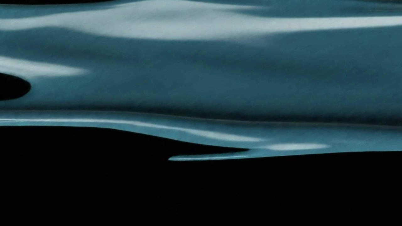 Blue Liquid Flowing Down Against a Black Background