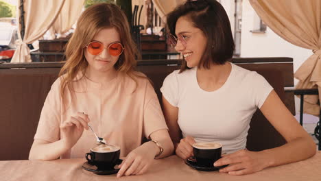 two friends enjoying coffee outdoors