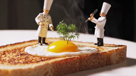 miniature chefs carefully garnishing freshly fried egg with delicate dill sprigs, placing perfectly on crisp toasted bread slice, showcasing intricate culinary craftsmanship