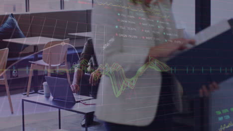 Animation-of-stock-market-data-processing-against-two-diverse-men-discussing-over-laptop-at-office