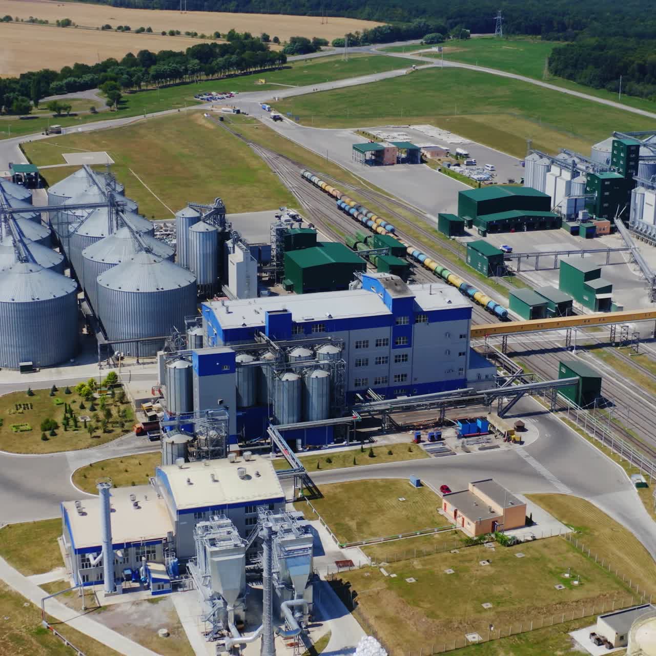 A landscape shot of a grain elevators. Plant in field. Aerial view.