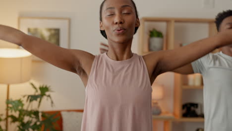 a healthy black couple doing yoga