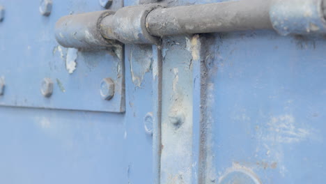 Strong-traditional-rusted-old-door-latch-closeup-with-keyhole-besides