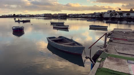 fishing boats at sunset on a calm river