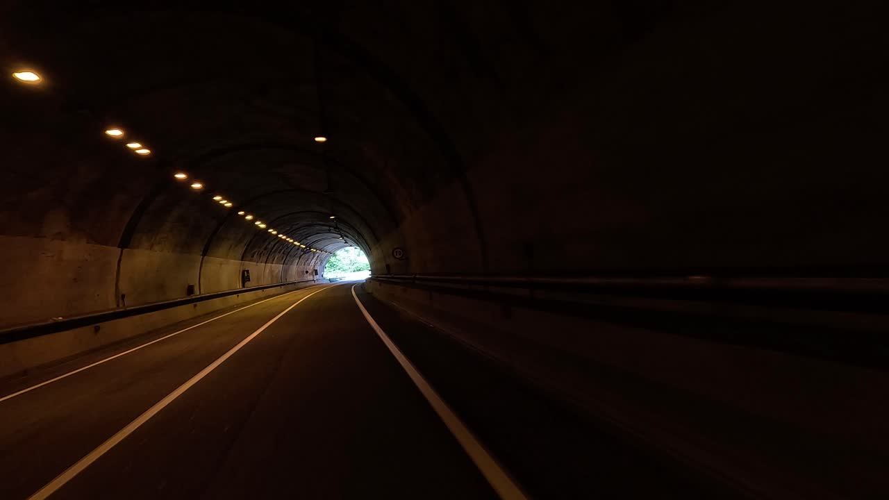 Vehicle moving through a tunnel towards daylight