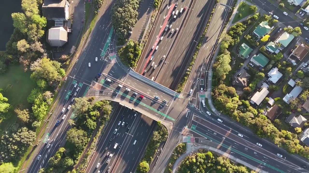 Top down drone view over busy highway interchange and overpass on Northwestern Motorway in Auckland, New Zealand