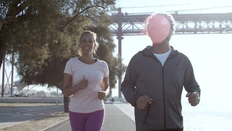 front view of joggers running in sunny day outdoors