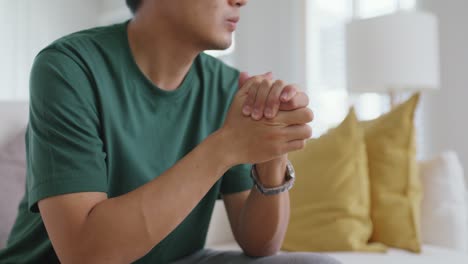 asian man sitting at sofa thoughtful fatigue looking away at home.