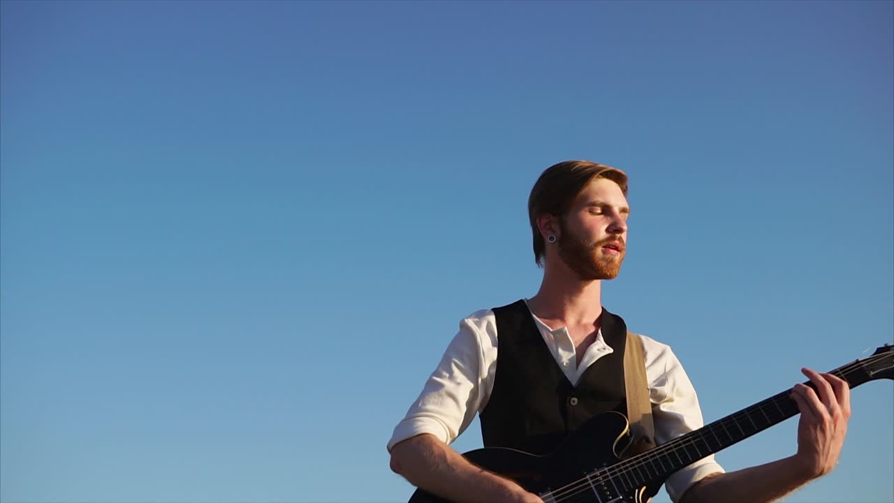 Man Playing Guitar Outdoors