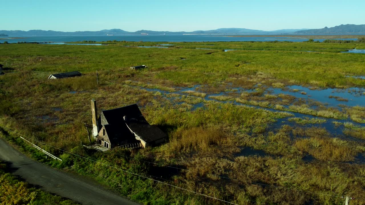 US, OR, Svenson, 2025-10-21 - Drone view of sunken and abandoned housees on an offshoot of the Columbia River near Astoria, Oregon in Fall