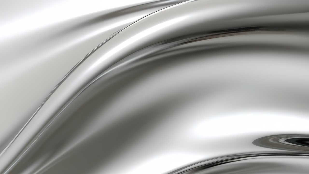 A smooth, metallic liquid surface with flowing curves. Captured from a top-down angle