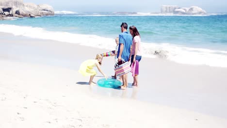 young family walking together with picnic stuff