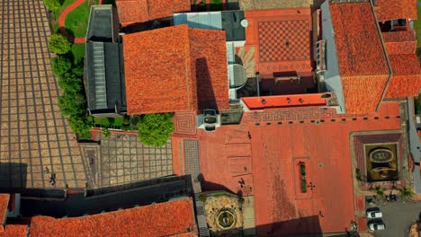 aerial overhead view establishing the main square of the town of guatavita, architecture with tiles and stone, sunny day in a tourist town near bogota, colombia.