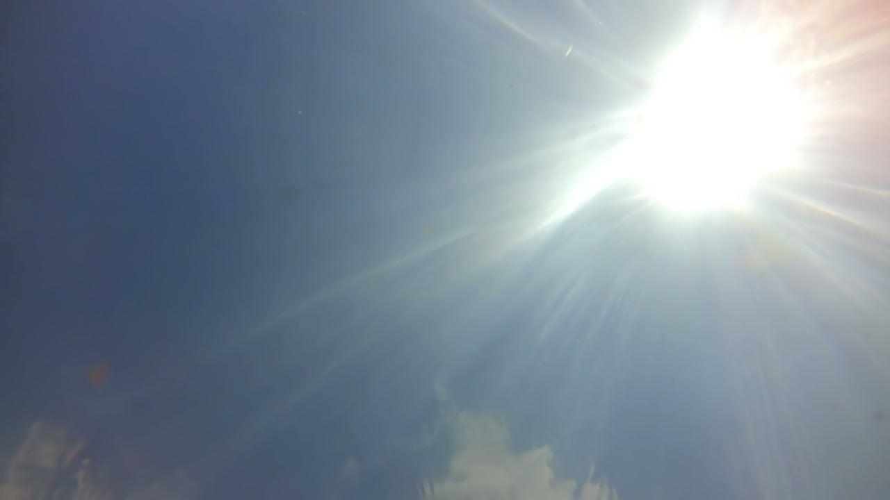 Registro do sol através da água no rio. Luz do sol no rio.