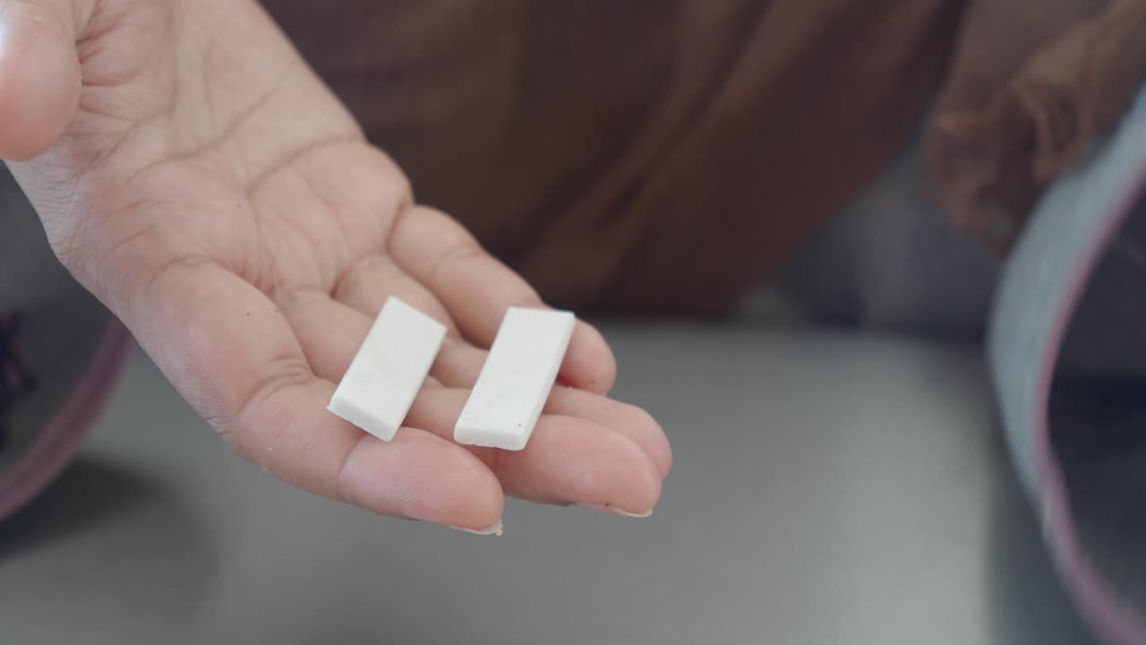 Close up shot of a pair of hands holding white objects
