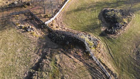 Aerial-Shot-Of-Rustic-Scandinavian-Farm-Fence-In-Agricultural-Farm-Land,-Scenic-Countryside