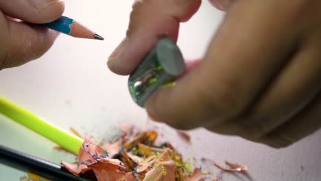 Footage-of-hands-slowly-sharpening-a-pencil-and-some-coloured-pencils-with-a-Wedge-Pencil-Sharpener