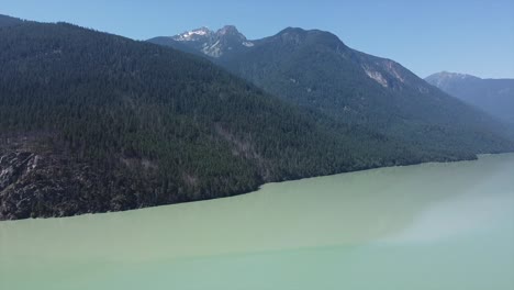 mountains densely covered with conifer trees at lillooet lake in british columbia, canada