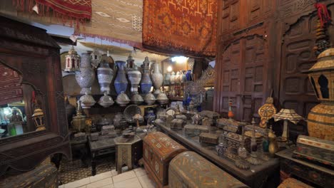 ouvenir shopping stall multi colored lamps are seen for sell. etched brass oil cruet., carpets, mirror and ornament shop. colorful texture background footage.