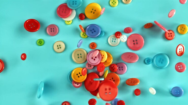 Slow Motion of Colorful Buttons Falling on a Blue Background