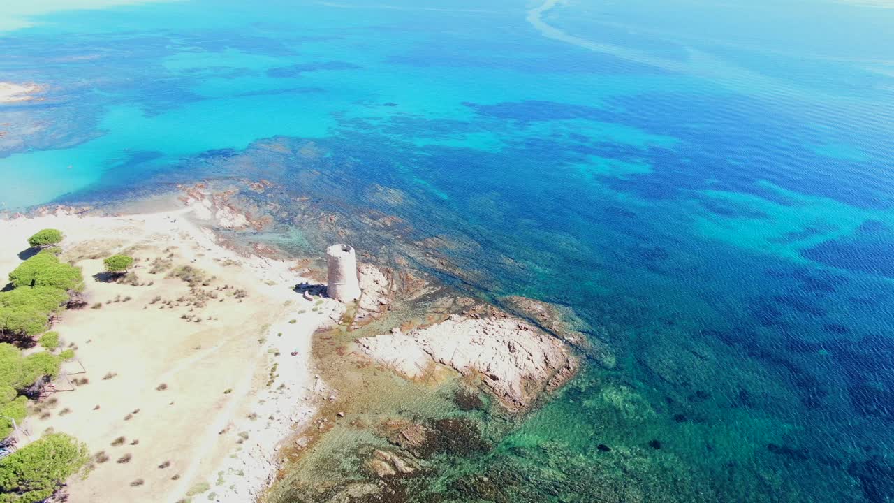 Historic tower on the coast, blue crystal clear water.