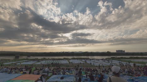 large outdoor gathering by the river