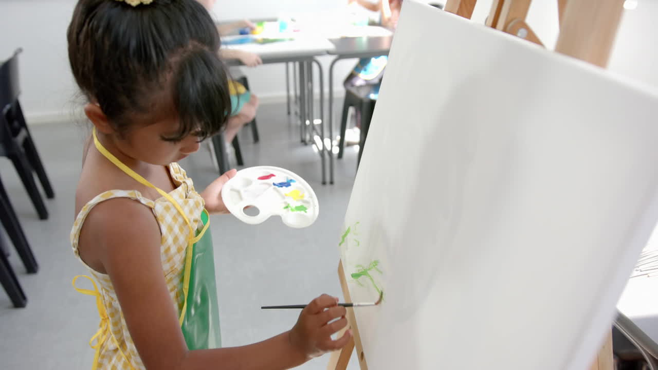 Painting on canvas, child in classroom with Back to School animation over