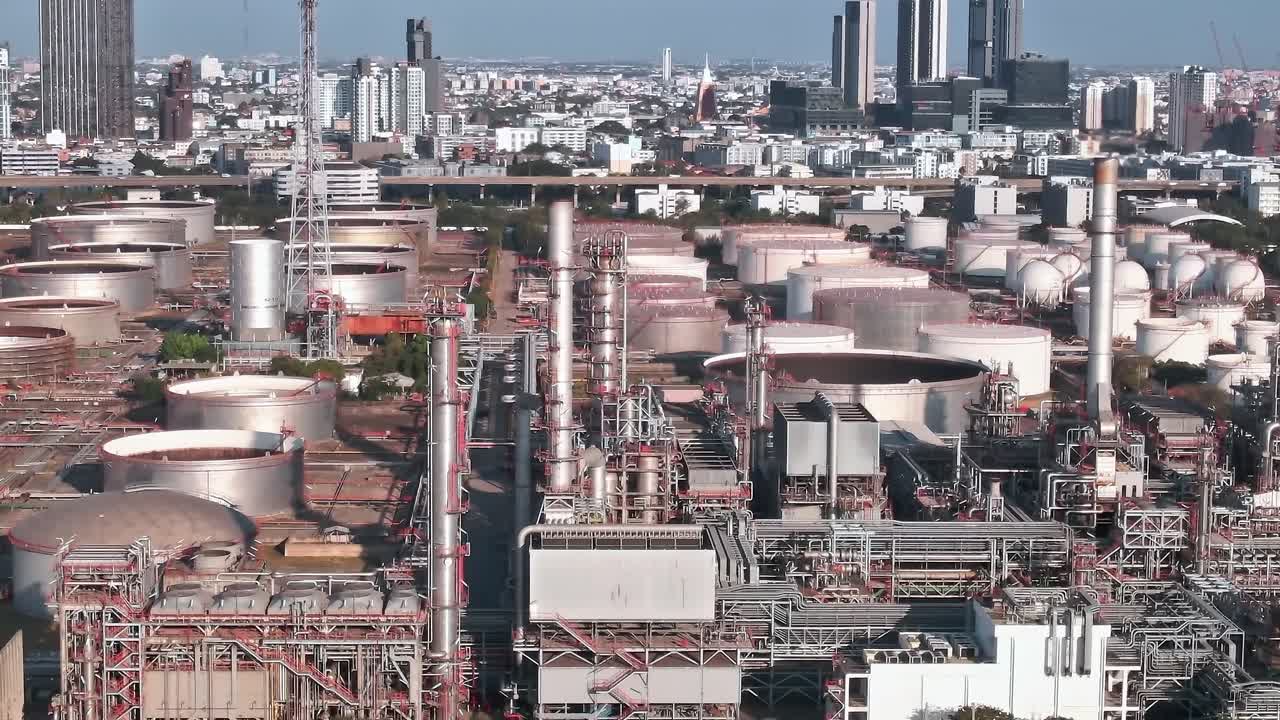 View of industrial area in Bangkok with storage tanks and city skyline