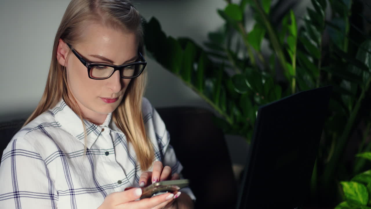Female Professional Messaging On Cellphone At Workplace